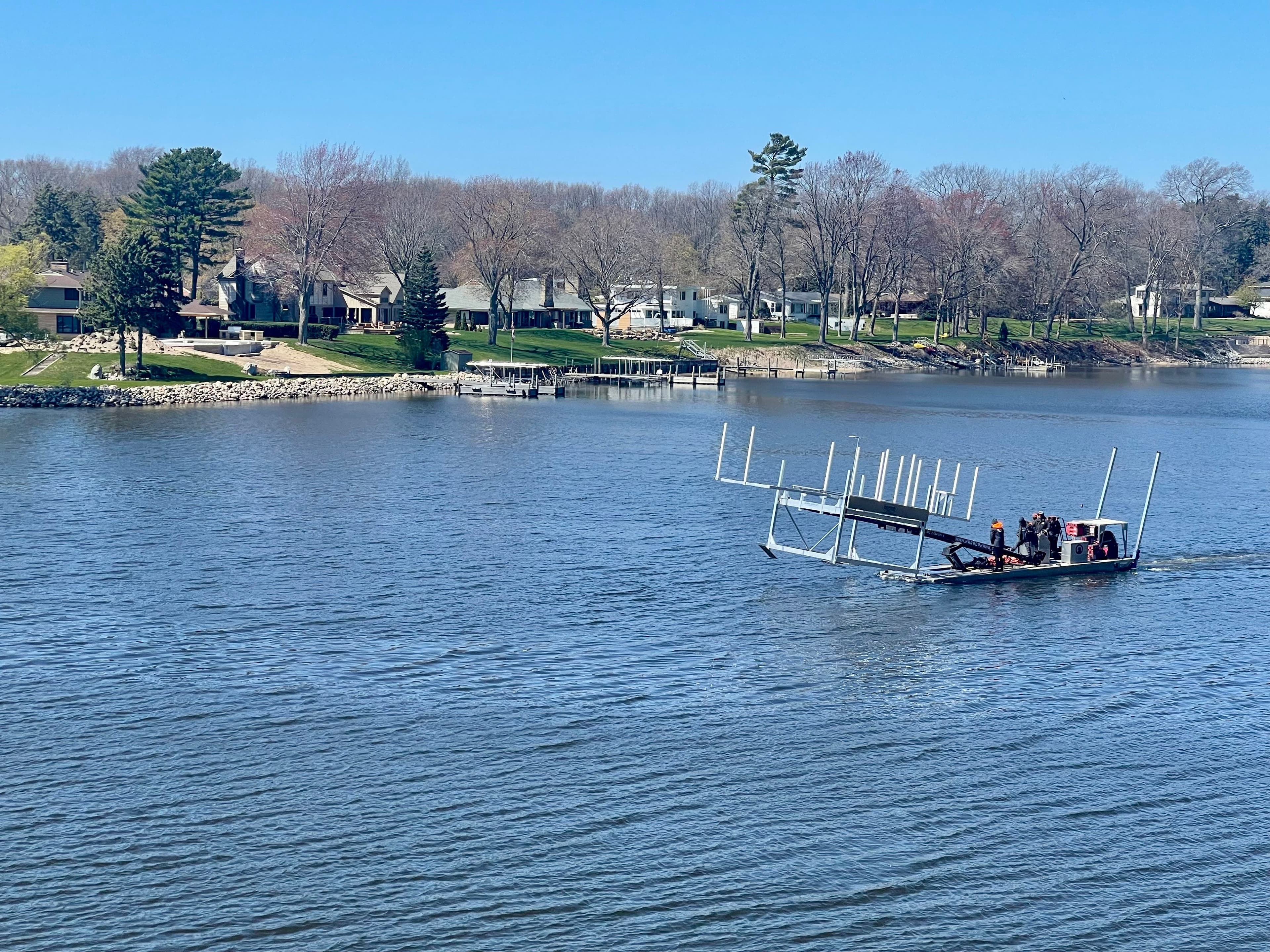 Boat lift being transported by water on Mona Lake