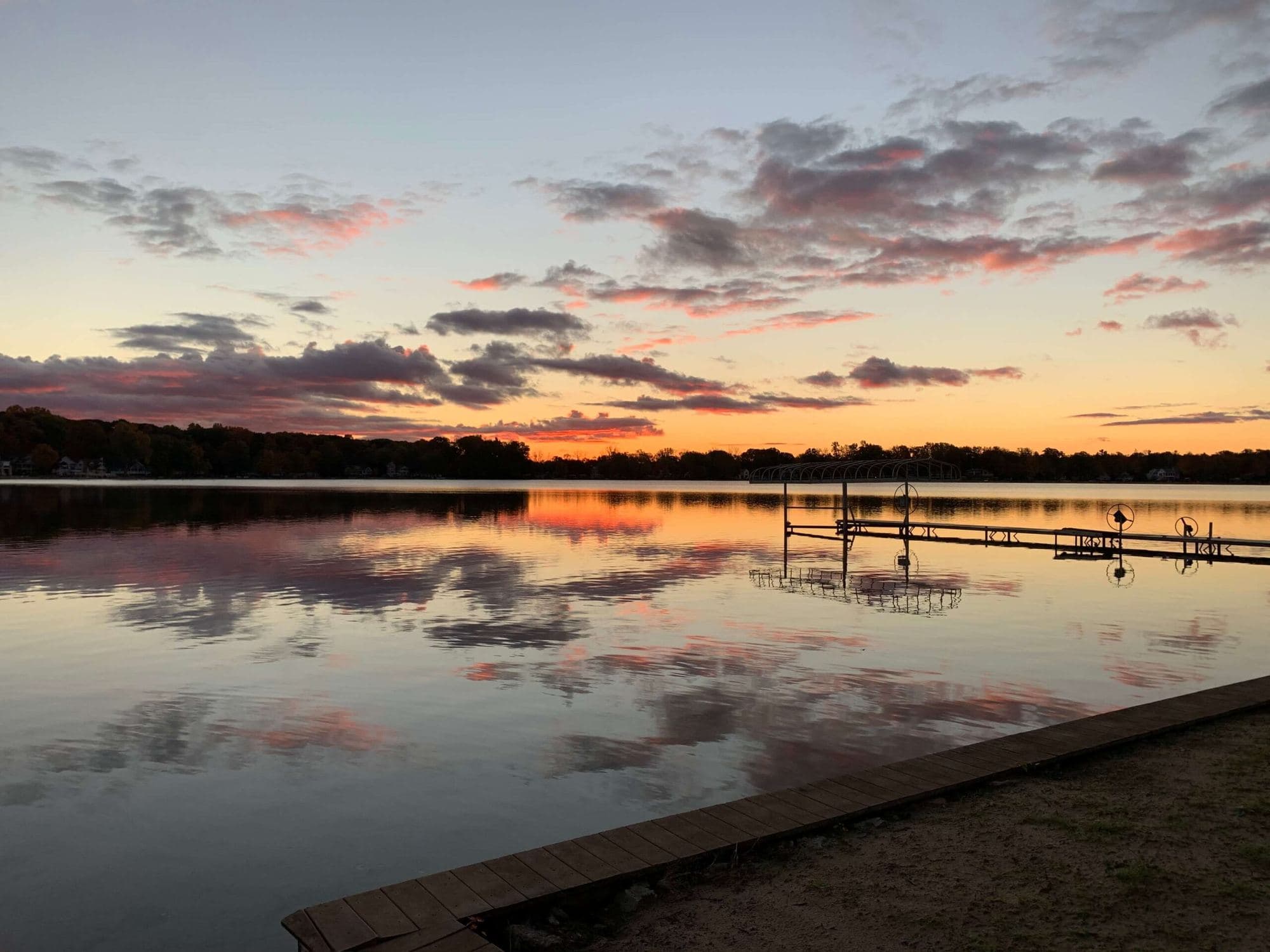 Sunset over Sand Lake with a dock in the foreground
